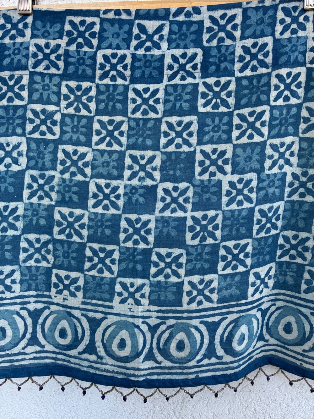 Blue & white  batik patterned short curtain or valance with beaded trim.